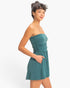 Beach Rose Co. strapless teal romper with shirred waist and side pockets worn by a model against a white background