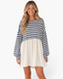 Beach Rose Co. navy and ivory striped babydoll mini dress with long billowy sleeves and a gathered skirt on a model