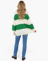 Beach Rose Co. green and cream striped acrylic sweater with balloon sleeves, back view on a model with blue jeans.