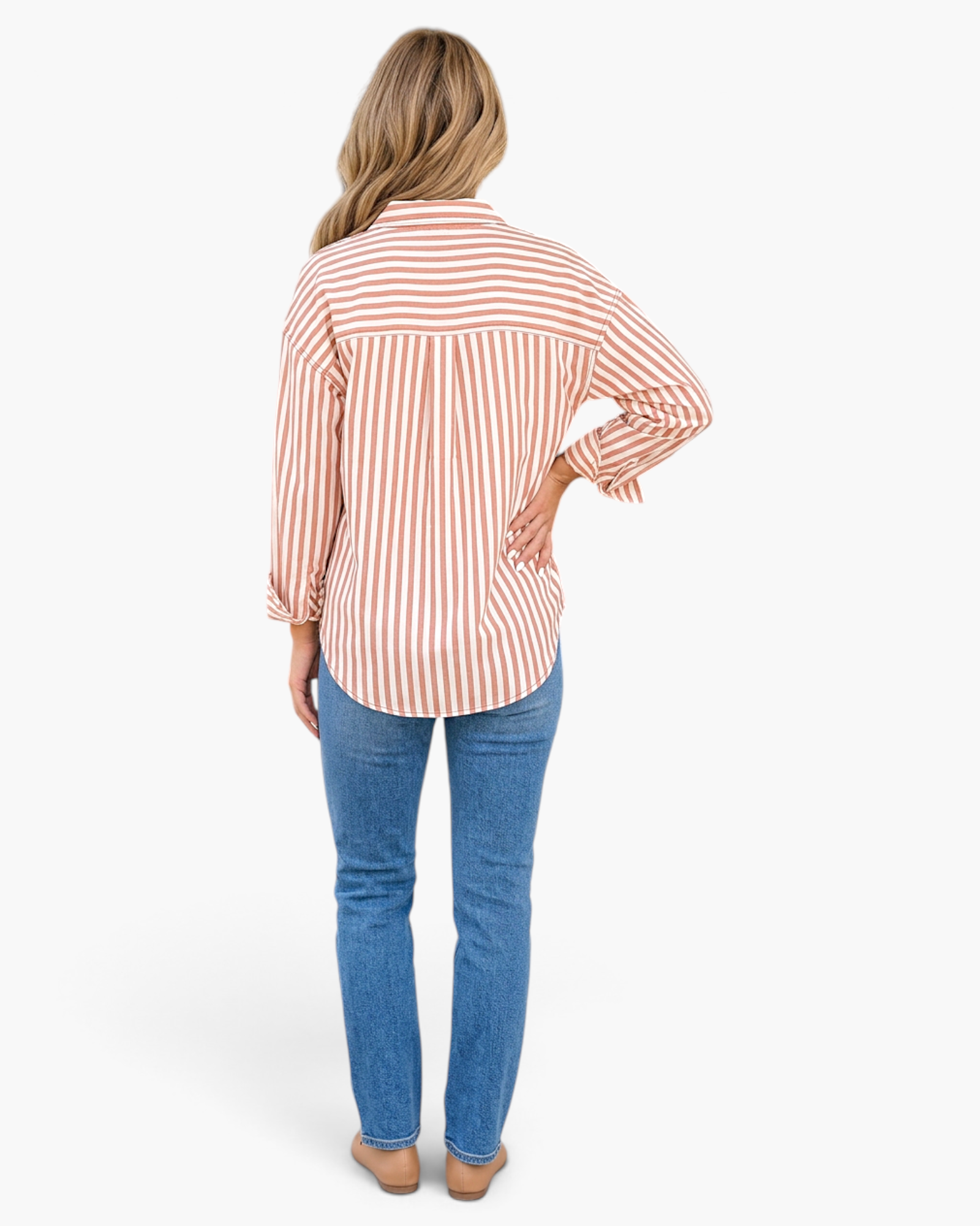 Beach Rose Co. brown and cream vertical striped button-up shirt with a relaxed fit and curved hem, worn with blue jeans