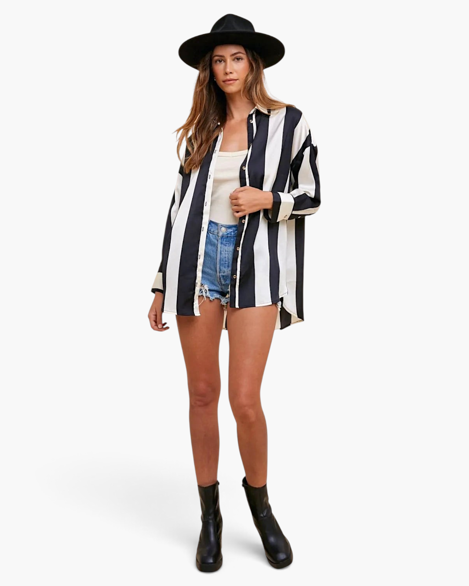 Model wearing Beach Rose Co. black and white striped button-up shirt with dropped shoulders, shorts, and black hat.