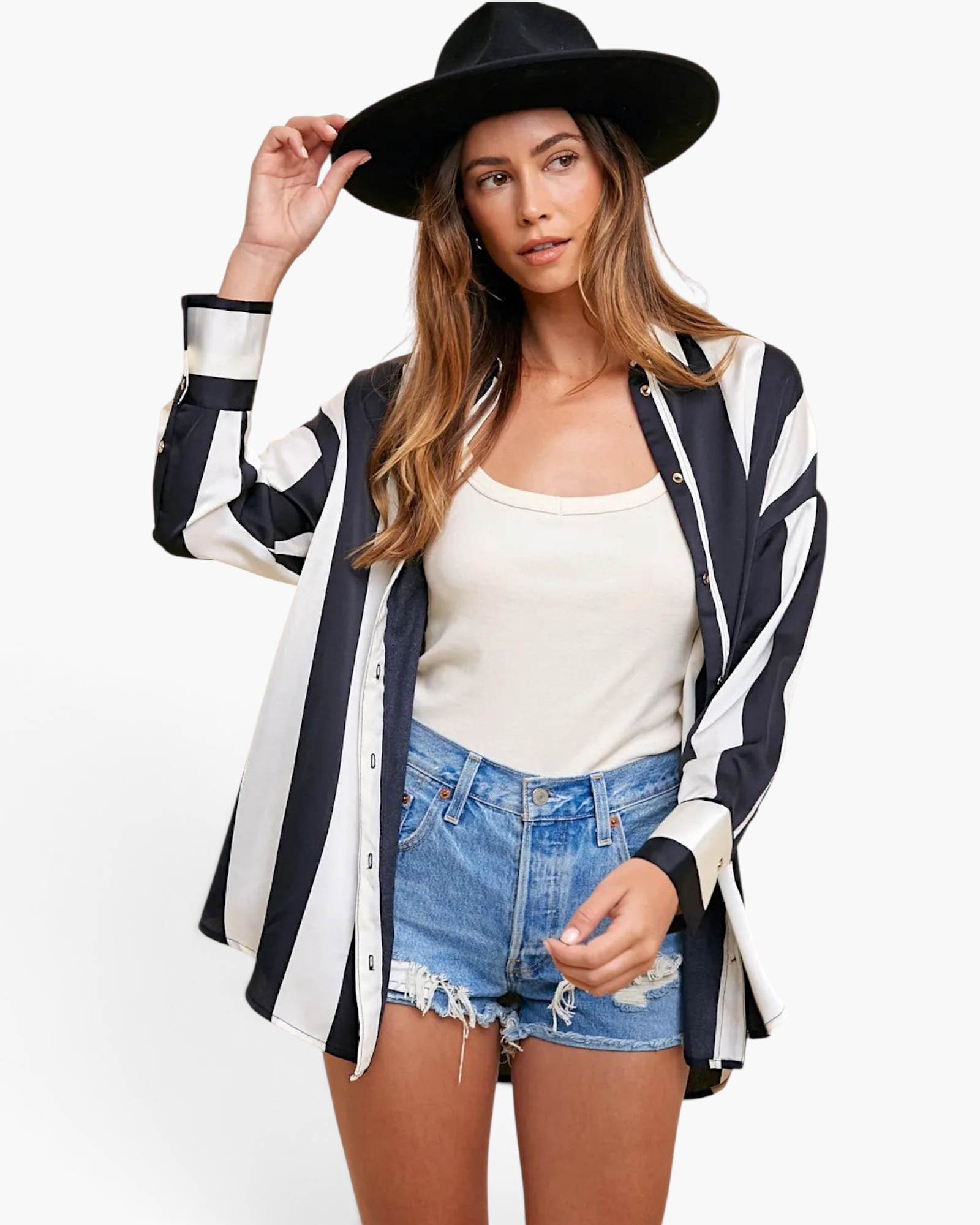 Beach Rose Co. black and white striped button-up shirt with dropped shoulders worn by a woman in a black hat.