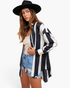 Beach Rose Co. black and white striped button-up shirt with dropped shoulders worn over a tank top and denim shorts.