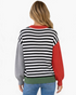 Beach Rose Co. black and cream striped sweater with color block sleeves, rust neckline, and olive hem, back view.