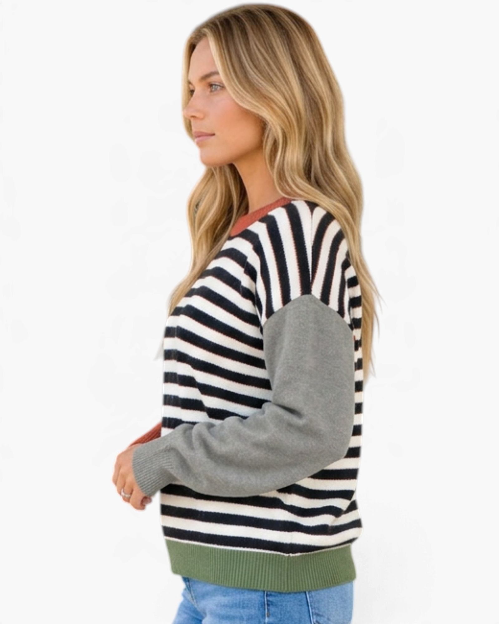 Beach Rose Co. model wearing a relaxed black and cream striped sweater with gray sleeves and an olive green hem.