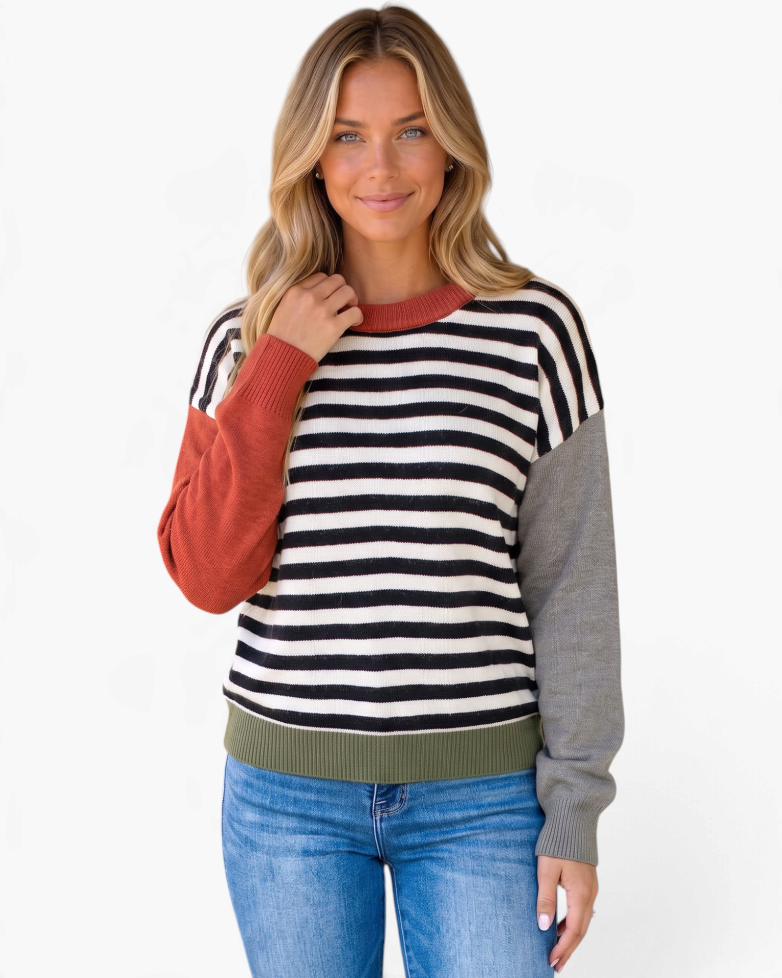 Beach Rose Co. model wearing a relaxed black and cream striped sweater with rust and gray color block sleeves.