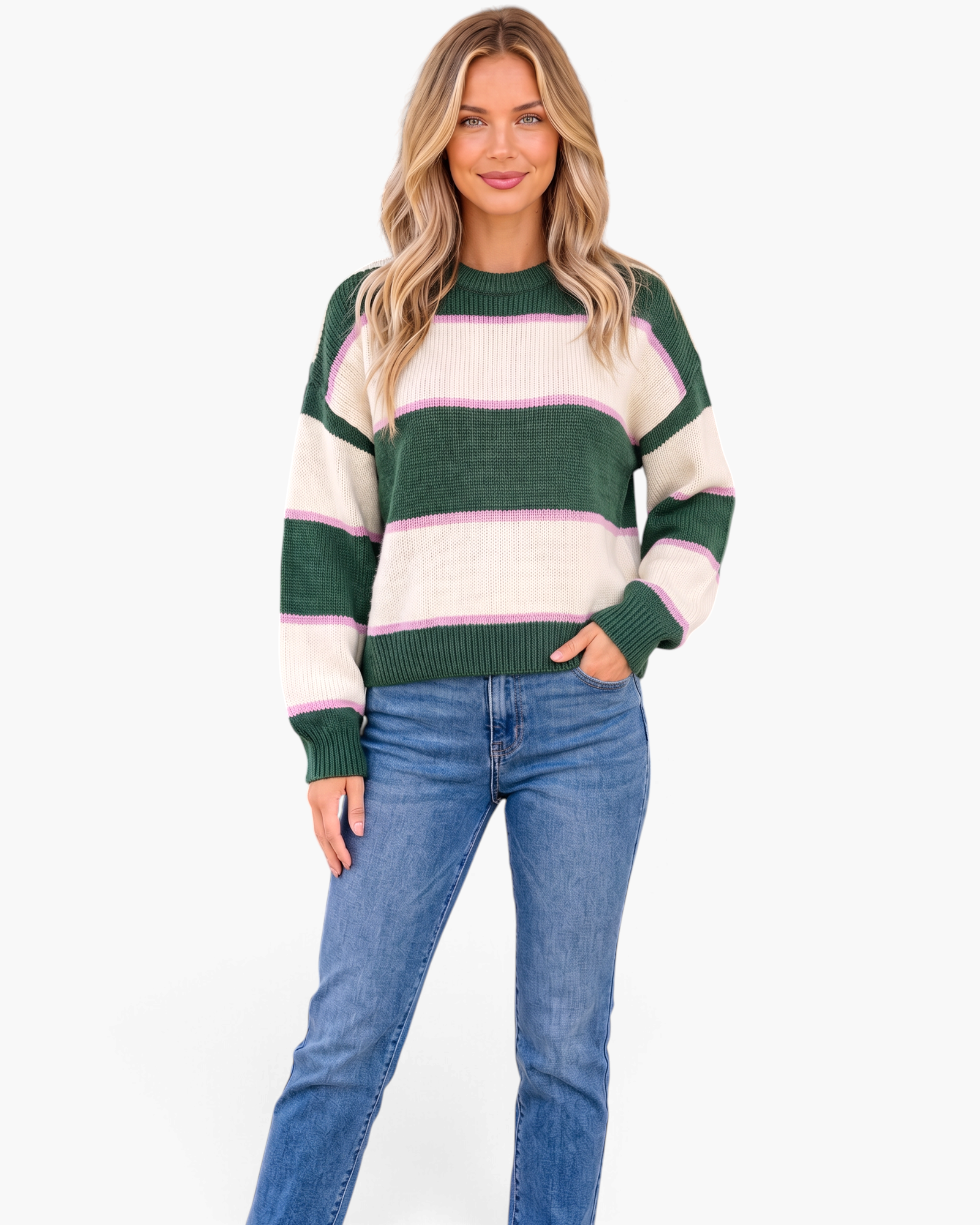 Beach Rose Co. model wearing a relaxed forest green and cream striped crewneck sweater with pink accents and jeans.