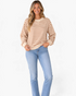Beach Rose Co. cream and brown striped cotton crewneck sweatshirt with dropped shoulders worn by a smiling model.