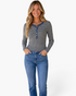 Beach Rose Co. gray and black striped long-sleeve Henley top with denim-look trim worn by a smiling blonde model.