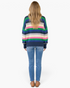Back view of a woman wearing a Beach Rose Co. navy multicolor striped textured knit sweater with jeans