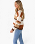 Beach Rose Co. Madilynne knit sweater with multi-color horizontal stripes, crew neck, and long sleeves on a model.