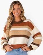 Beach Rose Co. multi-colored striped knit sweater with crew neck and long sleeves worn by a smiling blonde model