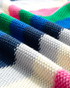 Beach Rose Co. navy sweater featuring a textured knit with horizontal multicolor stripes in blue, green, gray, and pink.