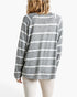Beach Rose Co. long sleeve top with black and white horizontal stripes and a round neck, back view on a model.
