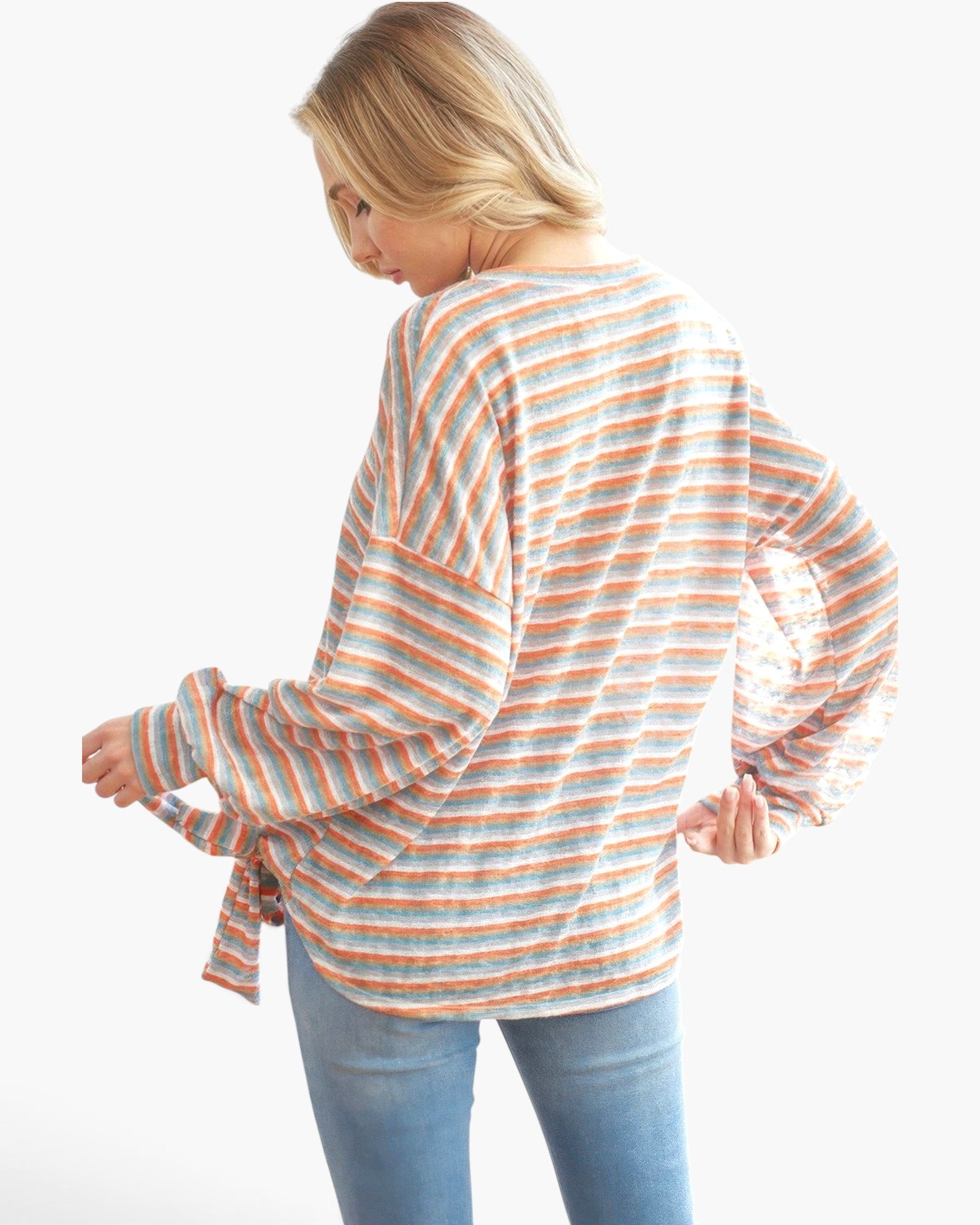 Beach Rose Co. long sleeve top in orange tri-tone stripes with a relaxed fit and side tie detail on a blonde model