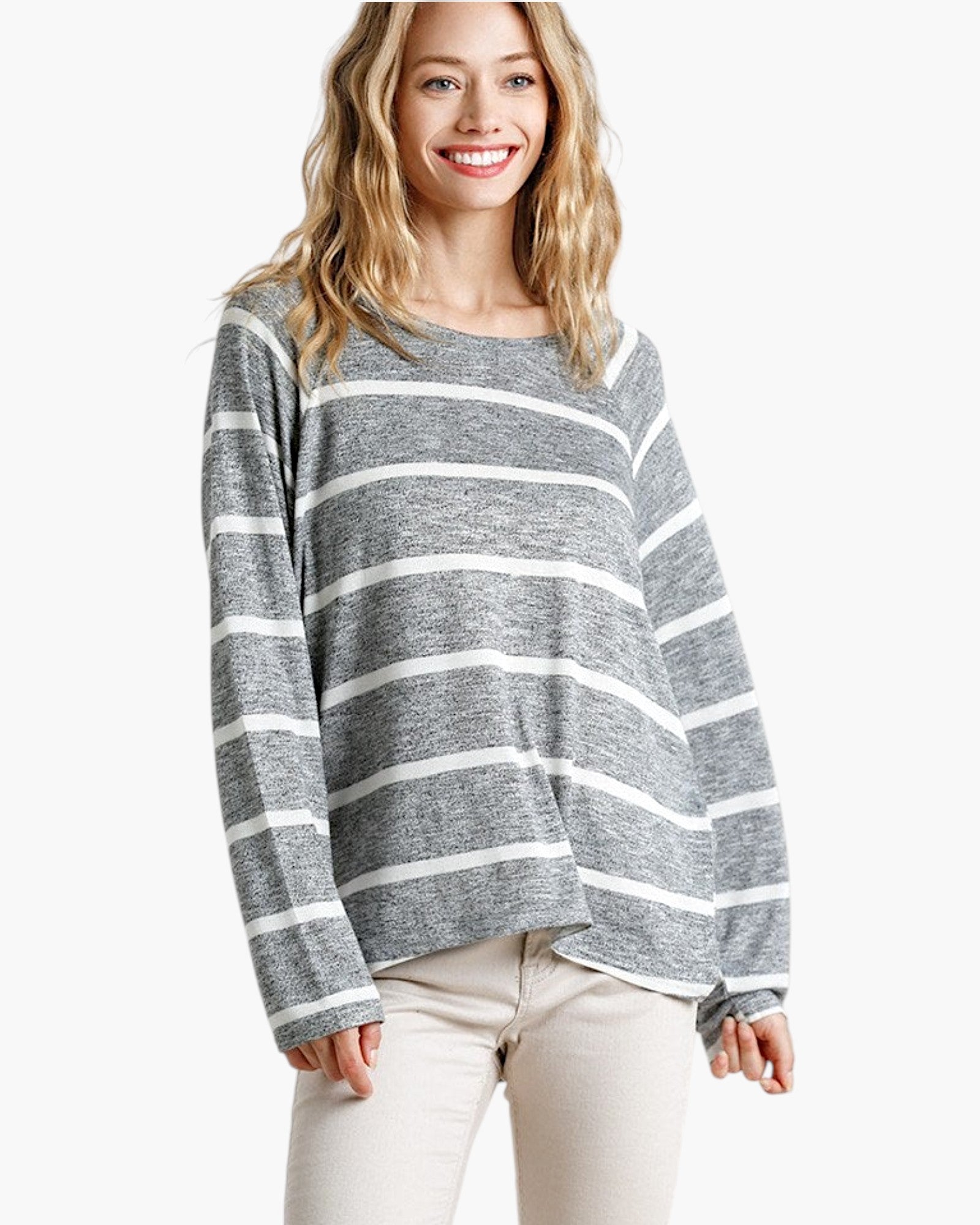 Beach Rose Co. model wearing a grey and white horizontal striped long sleeve top with a round neck