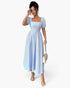 Beach Rose Co. blue and white striped midi dress with square neck and puff sleeves worn by a model with a handbag.