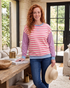 Beach Rose Co. plus size sweatshirt with pink and cream stripes, blue sleeves, and ribbed trim in a home setting.