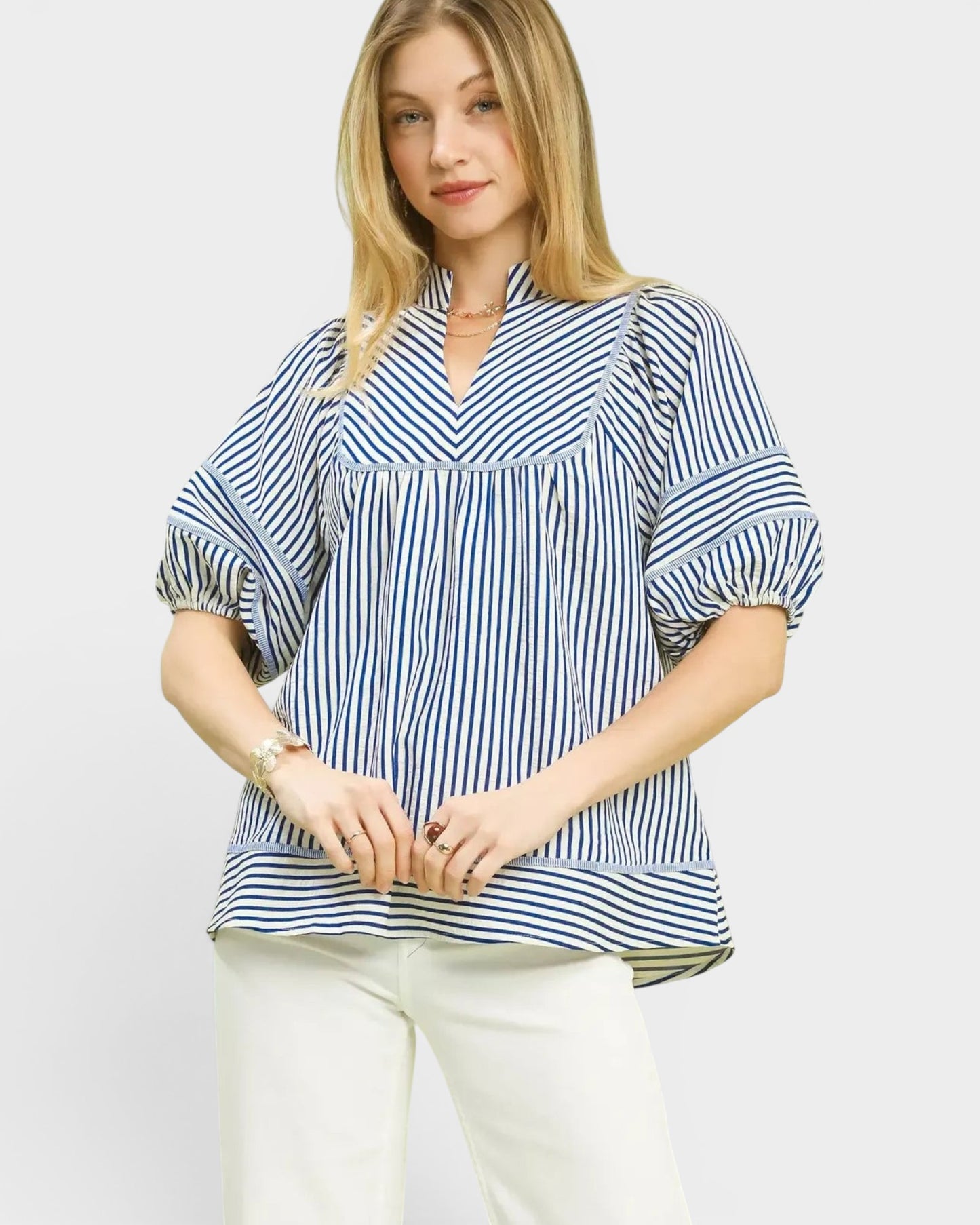 Beach Rose Co. blue and ivory striped puff sleeve top with V-neck and babydoll silhouette, made of cotton-polyester blend.