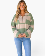 Beach Rose Co. model wearing a relaxed sage green and taupe striped quarter-zip pullover with contrast stitching.