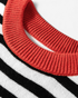 Beach Rose Co. black and cream striped sweater featuring a vibrant rust ribbed crew neckline in a soft knit blend.