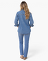 Beach Rose Co. blue denim shirt with metallic studs on sleeves, back view on a model wearing matching jeans