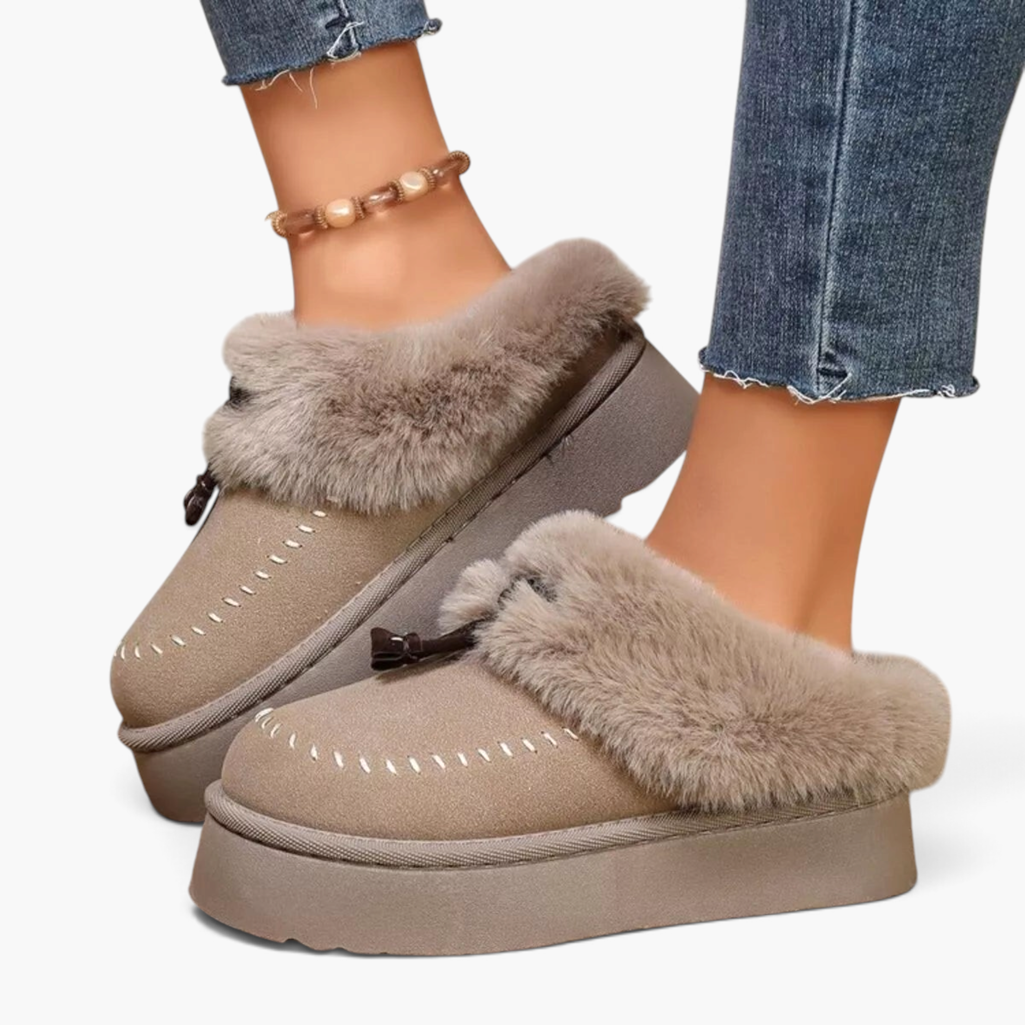 Beach Rose Co. beige suede platform clogs with plush faux fur trim, moccasin stitching, and decorative tassels.