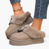 Beach Rose Co. beige suede platform clogs with plush faux fur trim, moccasin stitching, and decorative tassels.