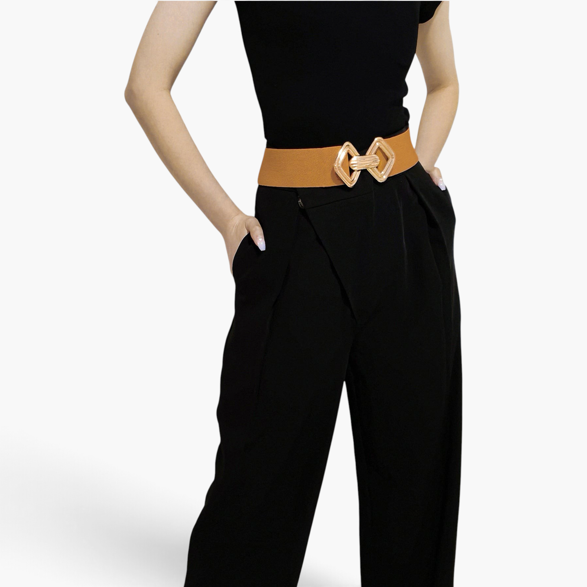 Beach Rose Co. tan elastic waist belt with a gold geometric double diamond alloy buckle worn over black trousers.