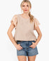 Beach Rose Co. tan striped top with floral flutter sleeves and a round neckline worn with denim shorts