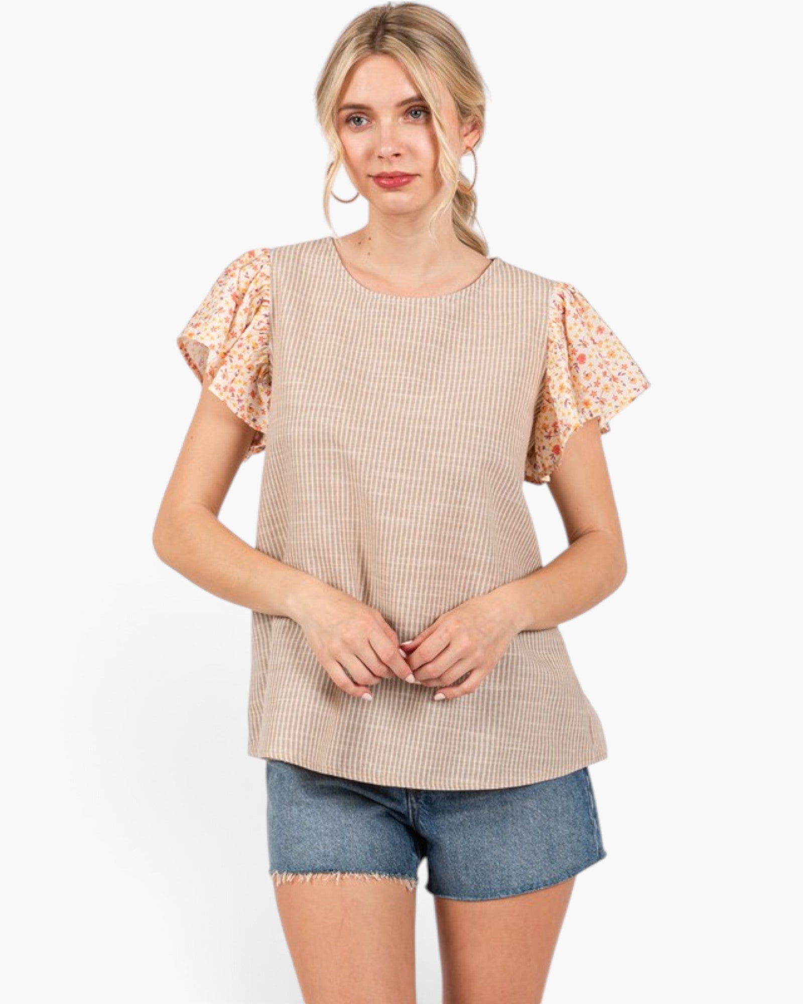 Beach Rose Co. tan and ivory striped top with floral flutter sleeves and a relaxed fit worn with denim shorts