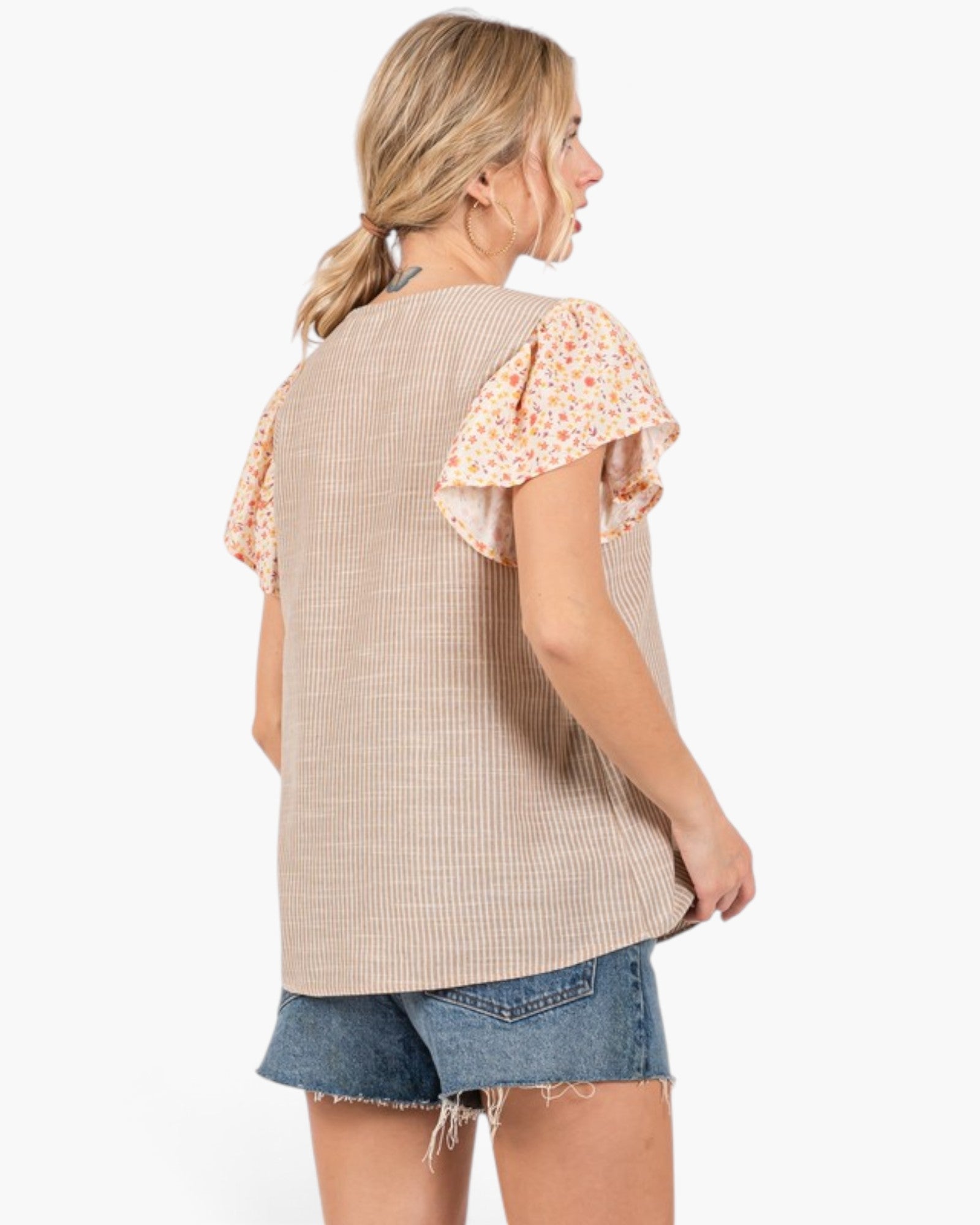 Beach Rose Co. tan striped top with floral flutter sleeves worn by a woman from the back view