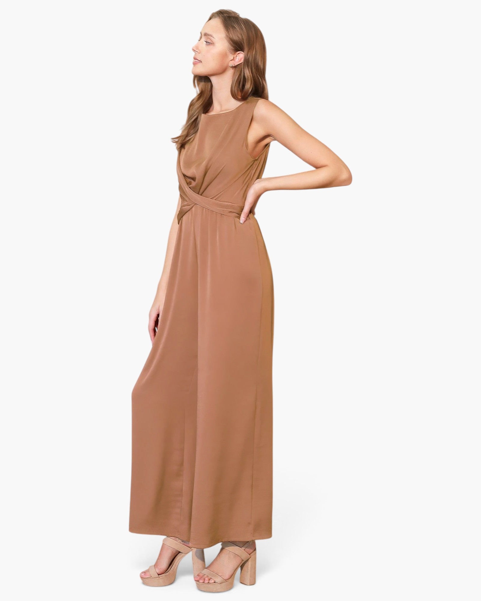 Beach Rose Co. washed poly silk jumpsuit in tan with a twist-front detail and fluid drape worn by a model.