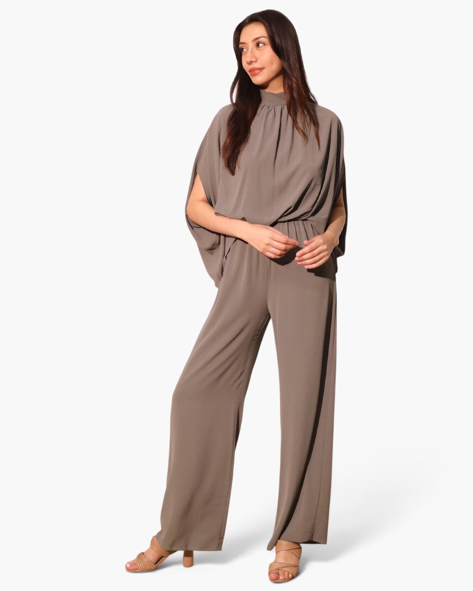 Model wearing a Beach Rose Co. taupe textured mock neck caftan jumpsuit with wide legs and flowing sleeves