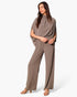 Model wearing a Beach Rose Co. taupe textured mock neck caftan jumpsuit with wide legs and flowing sleeves