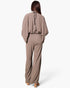 Beach Rose Co. taupe textured mock neck caftan jumpsuit with wide sleeves and a flowing silhouette, back view