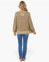 Beach Rose Co. taupe and charcoal diamond-knit sweater with a back patch detail worn with blue jeans