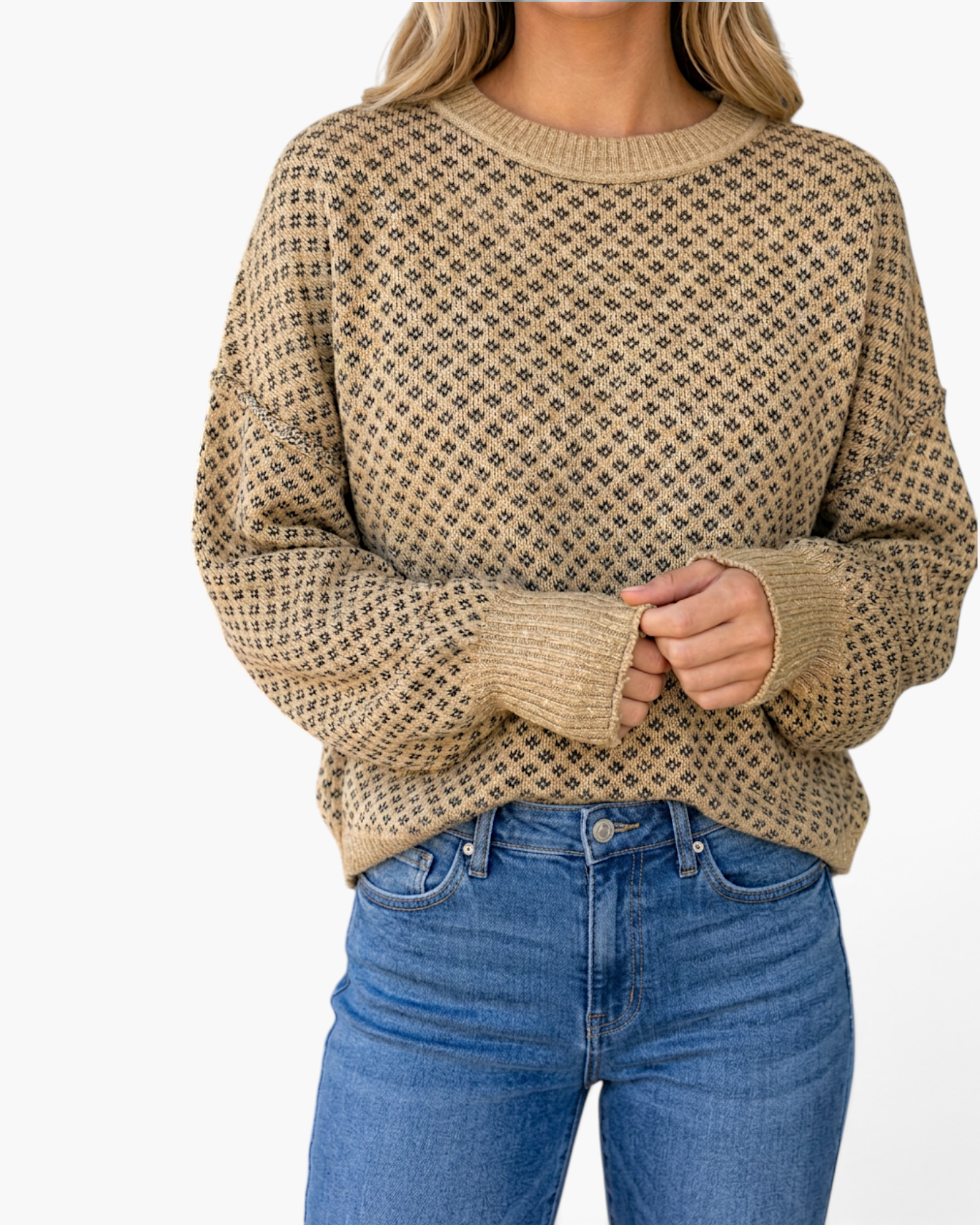 Beach Rose Co. taupe and charcoal diamond knit sweater with a round neckline and relaxed fit worn with blue jeans.