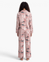Beach Rose Co. taupe pajama set with festive dinosaur print, featuring Santa-hatted dinosaurs on button-front top.