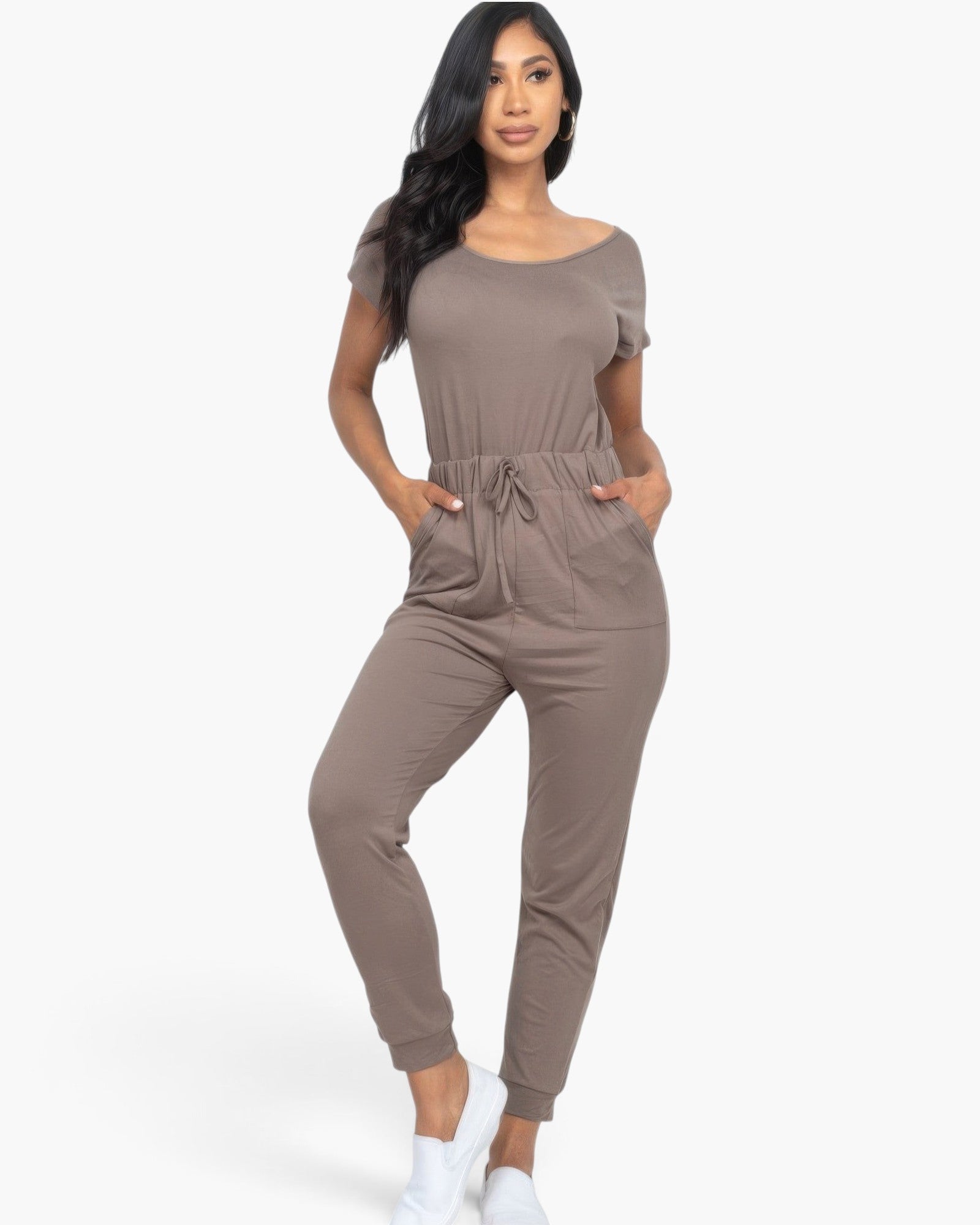 Beach Rose Co. taupe two-way shoulder drawstring jumpsuit with tapered legs and pockets worn by a model