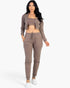 Beach Rose Co. taupe French terry three-piece lounge set with cropped cami, zip-up jacket, and tapered joggers on model