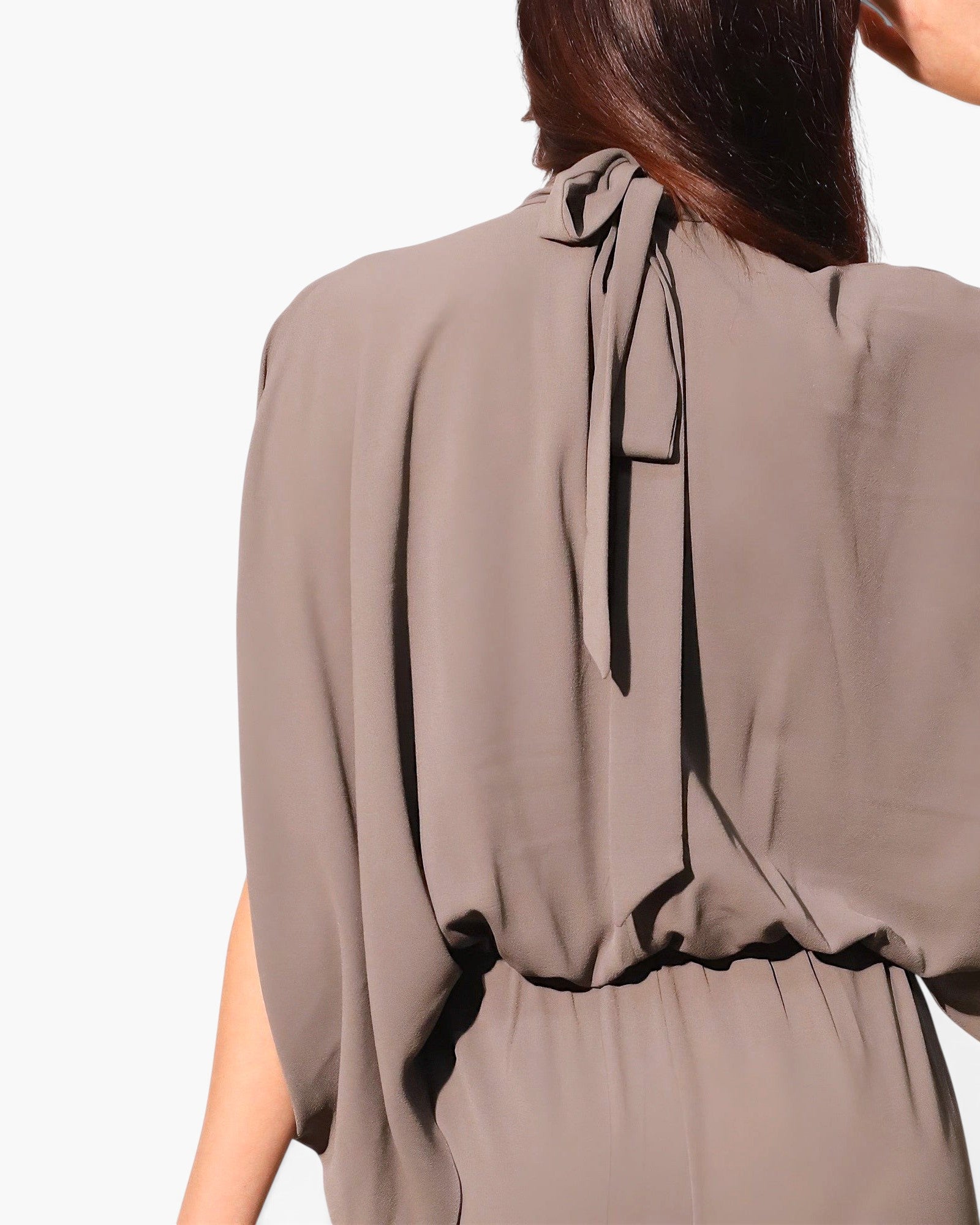 Beach Rose Co. taupe textured caftan jumpsuit featuring a mock neck with a back tie closure and flowing silhouette.