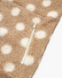 Beach Rose Co. taupe teddy jacket with cream polka dots and a functional zippered pocket detail.