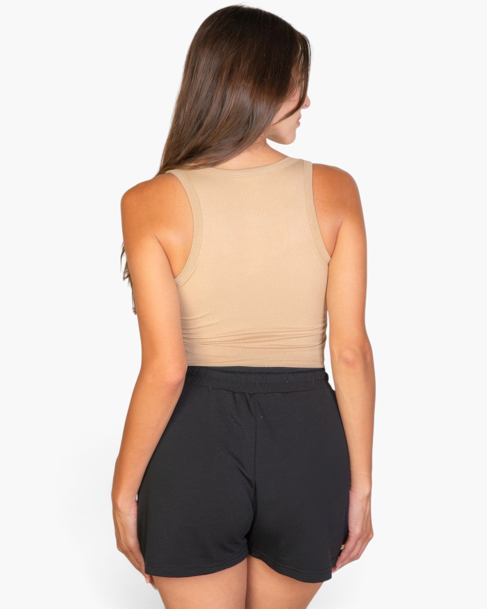 Beach Rose Co. taupe ribbed tank top worn by a woman from the back view, paired with black shorts.