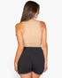 Beach Rose Co. taupe ribbed tank top worn by a woman from the back view, paired with black shorts.