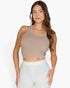 Beach Rose Co. taupe ribbed tank top worn by a woman, featuring a form-fitting design and soft, stretchy knit fabric.