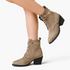 Beach Rose Co. taupe suede ankle boots with lace-up front, buckle strap, and chunky block heel on a model