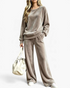 Beach Rose Co. taupe velour two-piece set with a relaxed crewneck top and wide-leg pants, worn with a white bag.