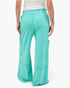 Beach Rose Co. teal mineral wash wide leg cargo pants with raw edge pockets and elastic waistband, back view