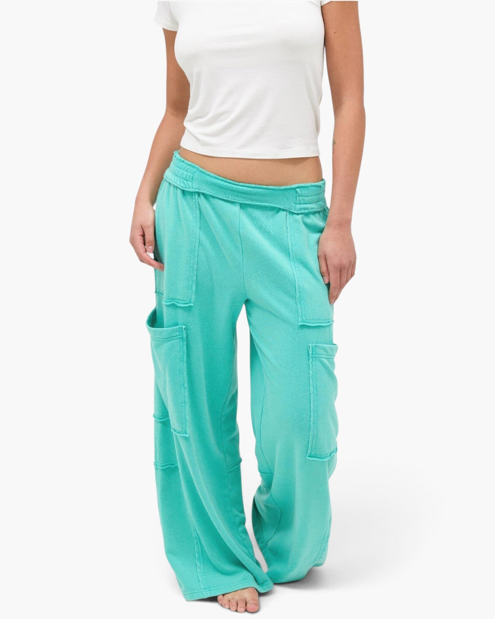 Beach Rose Co. teal mineral wash wide leg cargo pants with raw edge patch pockets and high-rise elastic waistband.